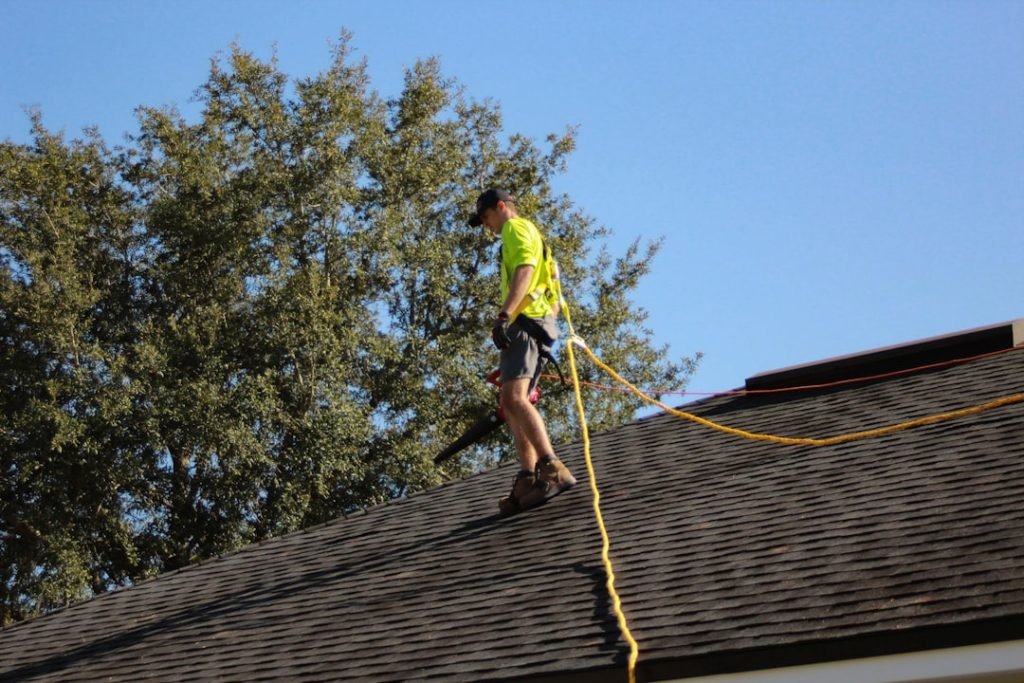 a-man-on-a-roof-working-with-a-rope-g8tyblq4p04